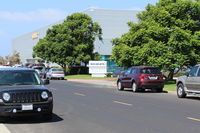  - SUN AIR JETS main street entry shown with one of their three large hangars. A 24/7 staffed business serving executive jets, with large ramps, transportation, fuel and maintenance. - by Doug Robertson