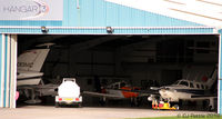  - A sneaky look inside Hangar 3 at Blackpool EGNH. Picture taken from the rear of the Morrisons Supermarket. - by Clive Pattle