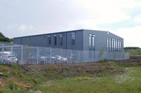  - Hangar for two air ambulance helicopters (G-WASN and G-HEMN) at the new Wales Air Ambulance base at Dafen, Llanelli, Wales, UK. - by Roger Winser