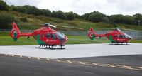  - The two Wales Air Ambulance helicopters (G-HEMN and G-WASN) at their new base at Dafen, Llanelli, Wales UK. - by Roger Winser