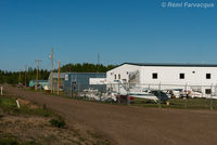  @ Fort Nelson Airport - View north down access road to private / corporate hangers, northeast portion of airport. - by Remi Farvacque