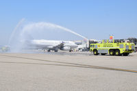  - ARFF giving water salute to aircraft carrying Olympic winners. - by Gerald Howard