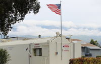  - Shifting winds today-Santana building strength forces active runway change to Rwy 04. Note flag at Fuel Dock. - by Doug Robertson