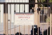  - Aviation Museum of Santa Paula-Days, Hours of Open House most First Sundays. This gate at airport entry parking lot otherwise locked. - by Doug Robertson