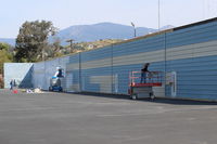  - Repainting Hangars in the western section of the airport; technically this is an off-original airport area. Hangar Owners here pay small fee annually to taxi to/from the 04-22 runway.  - by Doug Robertson