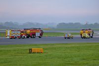  - man airport fire trucks waiting to cross runway 23R for 23L  - by andysantini