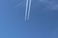  - N144X and N145HR doing a high near synonymous fast razzle dazzle with smoke high overhead arrival to SZP before landing.  - by Doug Robertson