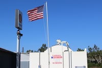  - Flag at SZP Fuel Dock showing stiff Santa Ana wind. Rwy 04 in use today. - by Doug Robertson