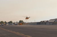  - Takeoff hover of a Thomas Fire FireBomber into a smoky sky. - by Doug Robertson