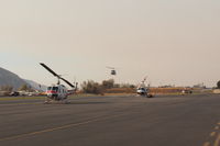  - Several Fire Base helicopters landed, one on short approach to the Santa Paula Fire Base. The Thomas Fire Base Airport is SZP.  - by Doug Robertson