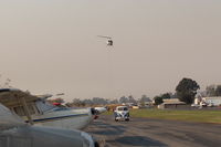  - Returning Helicopter Firebomber to SZP Thomas Fire Firebase with emptied retardant chemical. The Firebomber helos are using most all space at SZP. SZP closed to General Aviation flights. - by Doug Robertson