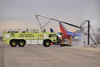 - ARFF unit practicing with water prob to puncture aircraft skin and introduce a water fog spray
into the aircraft's interior.  - by Gerald Howard
