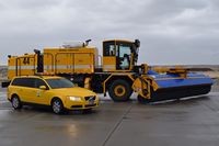  - The Volvo friction tester beside a new sweeper/blower combo in one truck. - by Gerald Howard