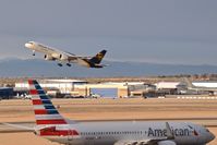  - UPS departing RWY 10R while American taxies to RWY 10L. - by Gerald Howard