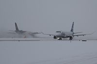  - Alaska taxiing on Alpha while UPS slows on a snow covered runway. - by Gerald Howard
