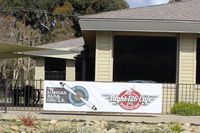  - The Airport's Flight 126 Restaurant serves food both inside and outside. This is a new banner facing the Transient Aircraft Ramp. - by Doug Robertson