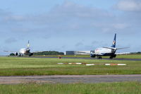  - YL-LCO and G-JMCS both on taxiway Charlie. - by Graham Reeve