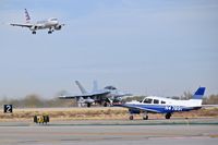  - A Piper on Taxiway Foxtrot while an EA-18G takes off on RWY 10R and American Airlines lands on RWY 10L. - by Gerald Howard