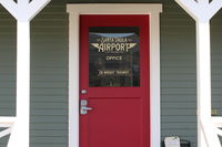  - Very classy information on SZP's Remodeled Airport Office front door. - by Doug Robertson