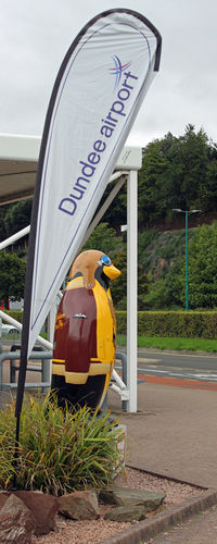  - The 'I Believe I Can Fly' Charity Penguin Statue at the entrance to Dundee Airport. Over 80 such penguins, in various paint schemes have been placed in and around local landmarks in the Dundee and County of Angus areas. Children have to find them. - by Clive Pattle
