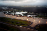  - Low Res Overview of a dark and wet Brisbane International Airport YBBN taken during the dusk departure of QantasLink Shorts S360-300 VH-SUM, heading for Bundaberg YBUD on 16Jan2002. - by Walnaus47