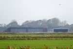  @ EDWS - Norden-Norddeich airfield hangars seen from a distance - by Ingo Warnecke