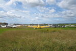  - An airshow at the former Vaerloese Air Base in Denmark. To the left Hangar 1. In the foreground KZ IV OY-DIZ, Harvard SE-FUB, Mustang LN-BMU and Spitfire LN-BSP. - by Jan Lundsteen-Jensen