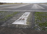  - One of the Runway 28 Threshold Lights at the closed Vaerloese Air Base in Denmark. The light lenses look reddish in the photo, but the light fixture emitted green light when turned on. Adjacent Runway End Light emitted red light in opposite direction. - by Jan Lundsteen-Jensen