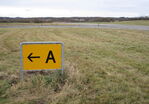  - Taxiway Alpha runway exit sign at Runway 10 in the eastern part of the closed Vaerloese Air Base in Denmark. The sign was removed some months later. - by Jan Lundsteen-Jensen