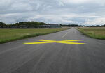  - Taxiway Charlie South at the closed Vaerloese Air Base in Denmark. Yellow crosses were painted on the taxiways shortly before the air base became a civilian area. Photo taken on last day as a military territory. - by Jan Lundsteen-Jensen