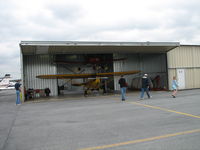Frederick Municipal Airport (FDK) - This guy had his hangar open so I took the shot.  That's what looked to me to be an old grumman cheetah on top but I'm not positive. - by Sam Andrews
