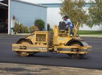 Santa Paula Airport (SZP) - Grading newly resurfaced asphalt aircraft ramp - by Doug Robertson