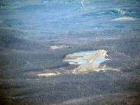 7SP Airport - Settled in the mountains as seen from approaching from the east - by Herb Harris