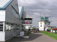 Sywell Aerodrome Airport, Northampton, England United Kingdom (EGBK) - View towards Tower past hangars at Sywell - by Simon Palmer