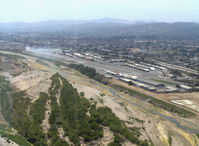 Santa Paula Airport (SZP) - Turning base for Rwy 22, off airport fire smoke in distance. Note: fire was burning brush, not an aircraft accident - by Doug Robertson