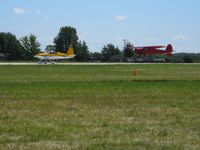 Wittman Regional Airport (OSH) - Launching two at a time on 36 at Airventure 2008.  N137RV (L) and N19498 (R). - by Bob Simmermon