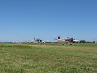 Wittman Regional Airport (osh) - N194RR (L) and N1328B (R) taxiing to depart 36. Airventure 2008 - Oshkosh, WI - by Bob Simmermon