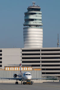 Vienna International Airport, Vienna Austria (VIE) - Fokker 100 pushing back in front of ATC tower - by Yakfreak - VAP