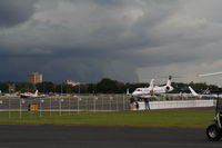 Executive Airport (ORL) - Stormclouds brewing over Downtown Orlando casting shadow on Orlando Executive Airport - by Florida Metal