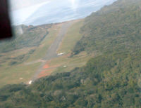 Ryans Creek Aerodrome - Stewart Island NZ, arriving in Islander ZK-FWZ - note parked Pa32 by threshold - by Pete Hughes