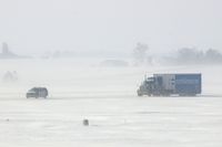 The Eastern Iowa Airport (CID) - Something you don't see everyday; safety escorts the U of I football team baggage truck on Taxiway Alpha - by Glenn E. Chatfield
