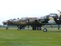 Duxford Airport, Cambridge, England United Kingdom (EGSU) - Mitchells nicely lined up waiting for the action - by Alex Smit