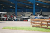 Wycombe Air Park/Booker Airport, High Wycombe, England United Kingdom (EGTB) - Busy hangar at Wycombe Air Park - by moxy
