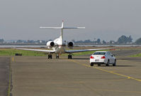 Napa County Airport (APC) - Planes and Cars share taxiway - NetJets Hawker 800XP N886QS departing for KMHR/Mather Field, Sacramento, CA with Chevy in trail - by Steve Nation