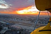 John Wayne Airport-orange County Airport (SNA) - Awesome sunset between Palos Verdes and Catalina Island, John Wayne airport (KSNA) and an open cockpit biplane - perfect view! - by bodypilot
