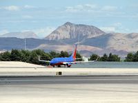 Mc Carran International Airport (LAS) - Southwest Airlines / Shimmering in the afternoon heat ready for take-off on RWY 25R. The mountain in the background is a Volcano. - by SkyNevada - Brad Campbell