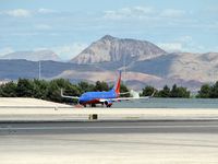 Harry Reid International Airport (LAS) - Southwest Airlines / Shimmering in the afternoon heat ready for take-off on RWY 25R. The mountain in the background is a Volcano. - by SkyNevada - Brad Campbell