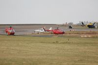 Swansea Airport, Swansea, Wales United Kingdom (EGFH) - North and Mid-Wales Air Ambulance helicopters and the South and East Wales Police Air Support Unit helicopter about to depart and join up with the South Wales Air Ambulance helicopter to celebrate the 10th anniversary of Wales Air Ambulance held in Margam - by Roger Winser