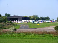 Elstree Airfield - hangar and parking area at Elstree - by Chris Hall