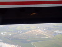 Boundry Bay Airport, Boundry Bay Canada (CZBB) - Boundary Bay, south of Vancouver, seen below the engine cowling of N431QX DHC8 flying SEA to YVR.  - by Pete Hughes